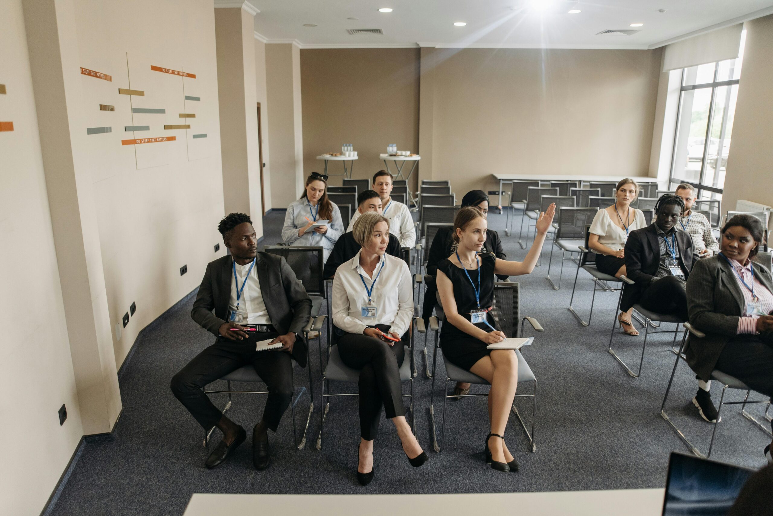 A group of diverse adults attending a business meeting in a modern conference room.