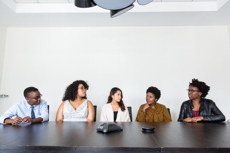 Home A diverse group of professionals having a meeting in a modern office setting. Teamwork and collaboration.