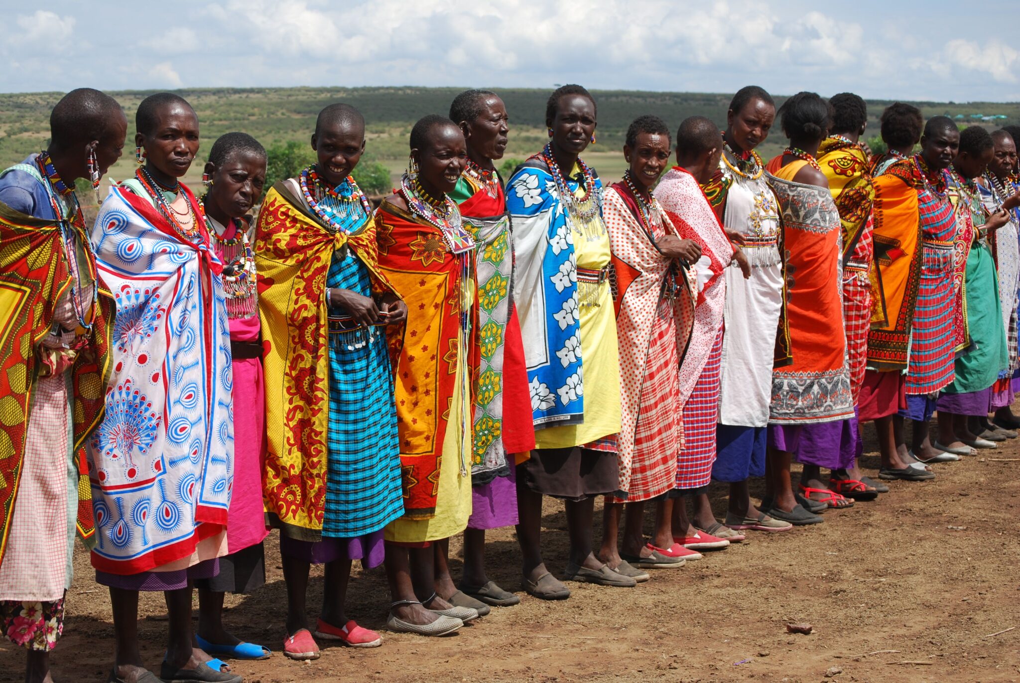 HopeWorks Global Kenya A vibrant display of Maasai women in traditional attire in Kenya, showcasing cultural heritage.